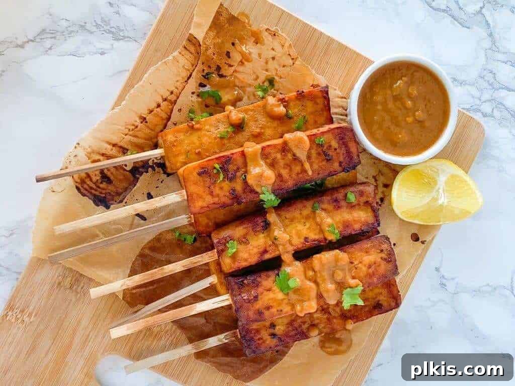 Oil-Free Tofu Satay with Peanut Sauce Oil-Free Tofu Satay with Peanut Sauce on a wooden board