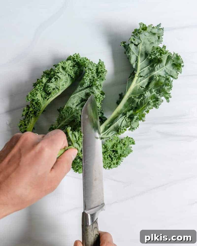 Guide to Kale: How to Remove The Stem Curly Kale Removing Stem on a Marble Surface