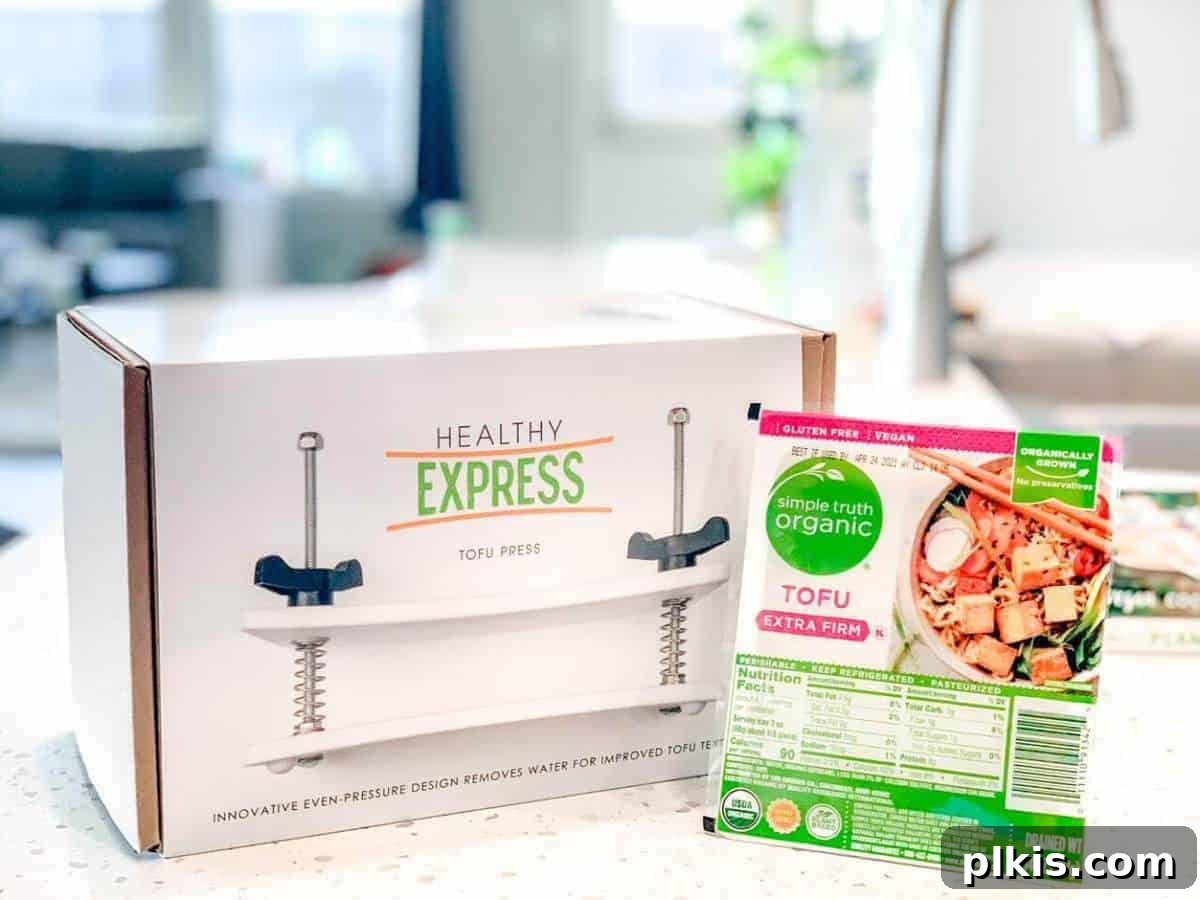 Guide to Tofu Pressing: Healthy Express Review Tofu Press by Healthy Express with a block of packaged tofu on a kitchen counter, showcasing its innovative design.
