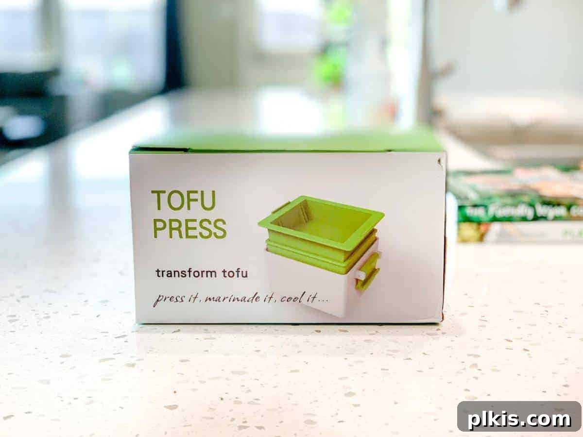 Guide to Tofu Pressing: Yarkor Tofu Press Review Yarkor Tofu Press in its packaging on a marble counter, highlighting its compact and elegant design.