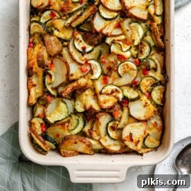 A golden-brown Zucchini Potato Bake, fresh out of the oven in a baking dish, promising warmth and flavor.