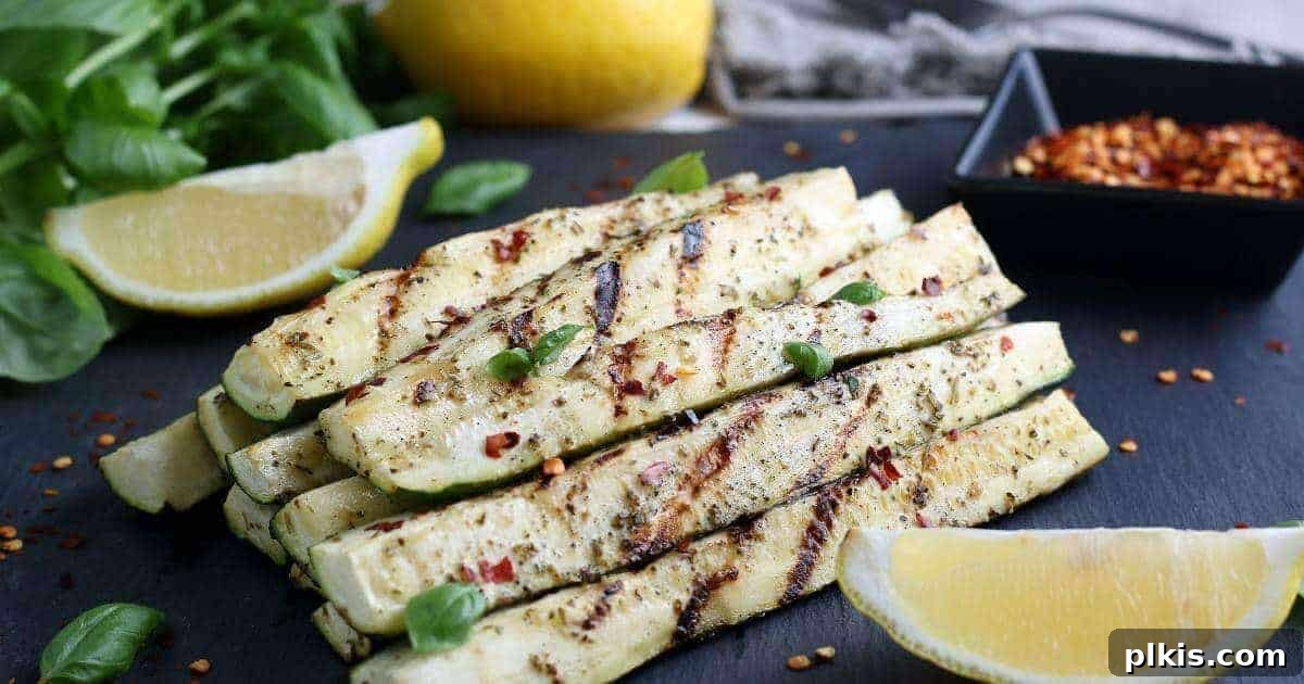 Grilled Zucchini Several perfectly grilled zucchini slices, beautifully arranged with a wedge of lemon against a dark background, showcasing their appetizing char.