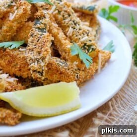 Golden brown baked zucchini fries, perfectly crispy and ready to serve.