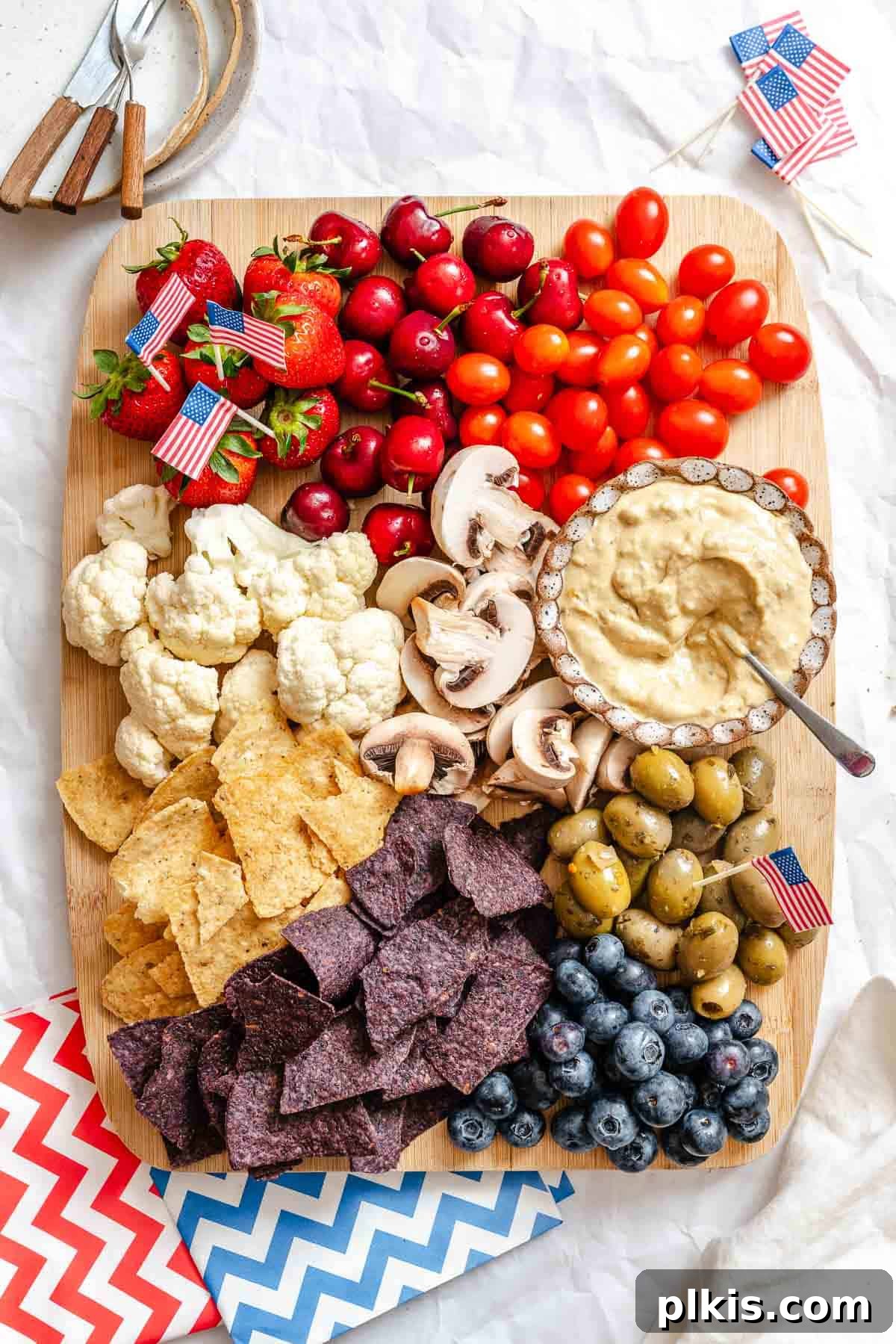 Red, White & Blue Charcuterie Board 2 A vibrant and festive 4th of July Charcuterie Board overflowing with red, white, and blue ingredients, beautifully arranged on a serving platter.