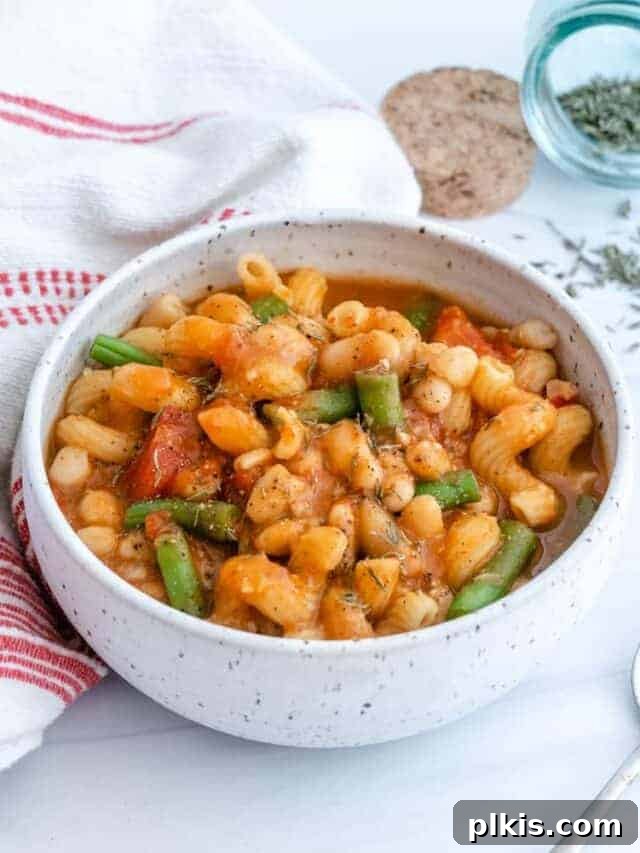 59 Creative Bean Can Hacks 3 completed Pasta Bean and Tomato Soup in a white bowl against a light surface