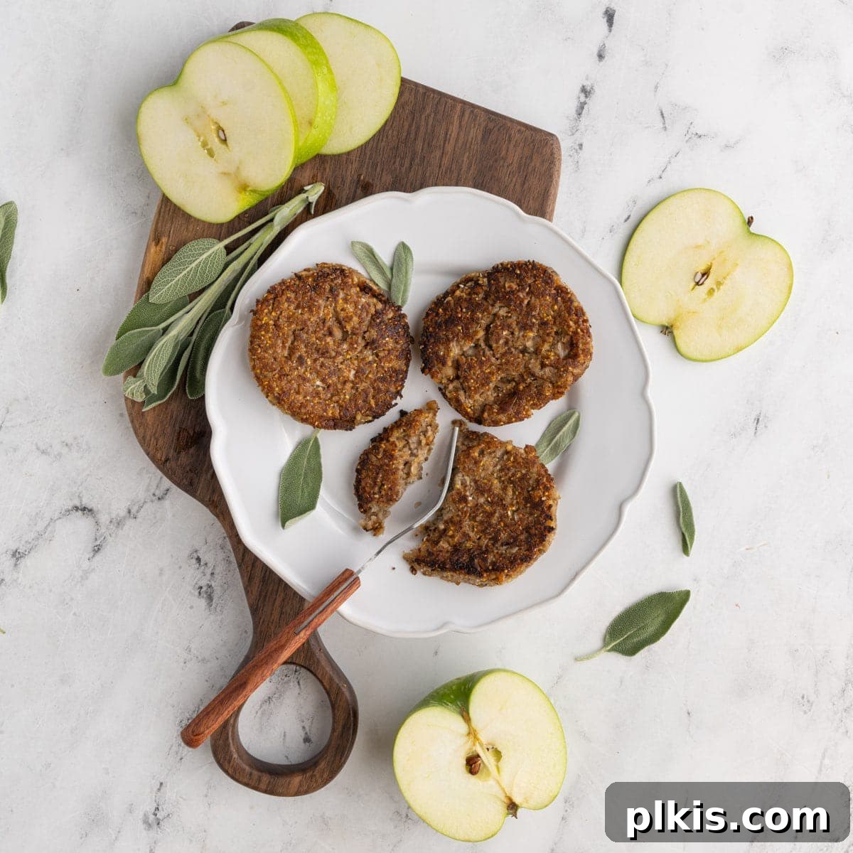 48 Irresistible Vegan Apple Delights 12 Completed Vegan Sausage Patties on a plate on a white surface.