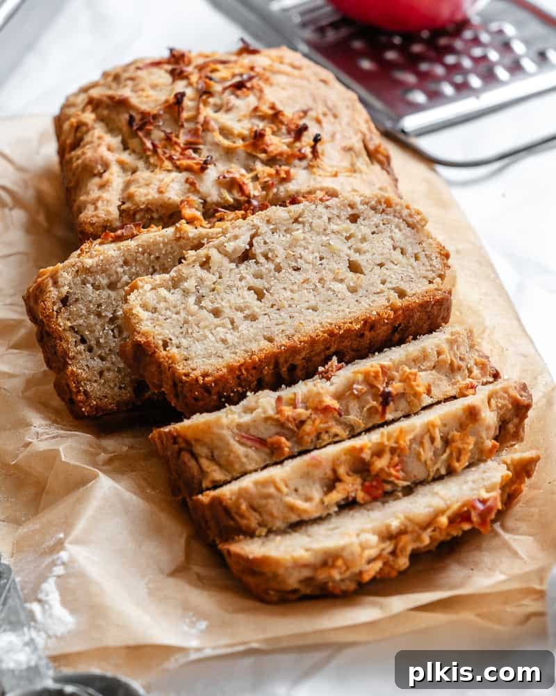 48 Irresistible Vegan Apple Delights 14 Completed sliced apple cinnamon bread on a piece of parchment paper.