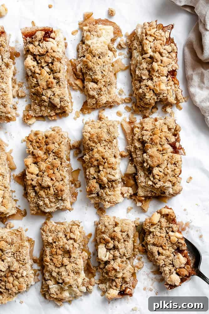 48 Irresistible Vegan Apple Delights 17 Completed Easy Apple Pie Bars on a white surface.