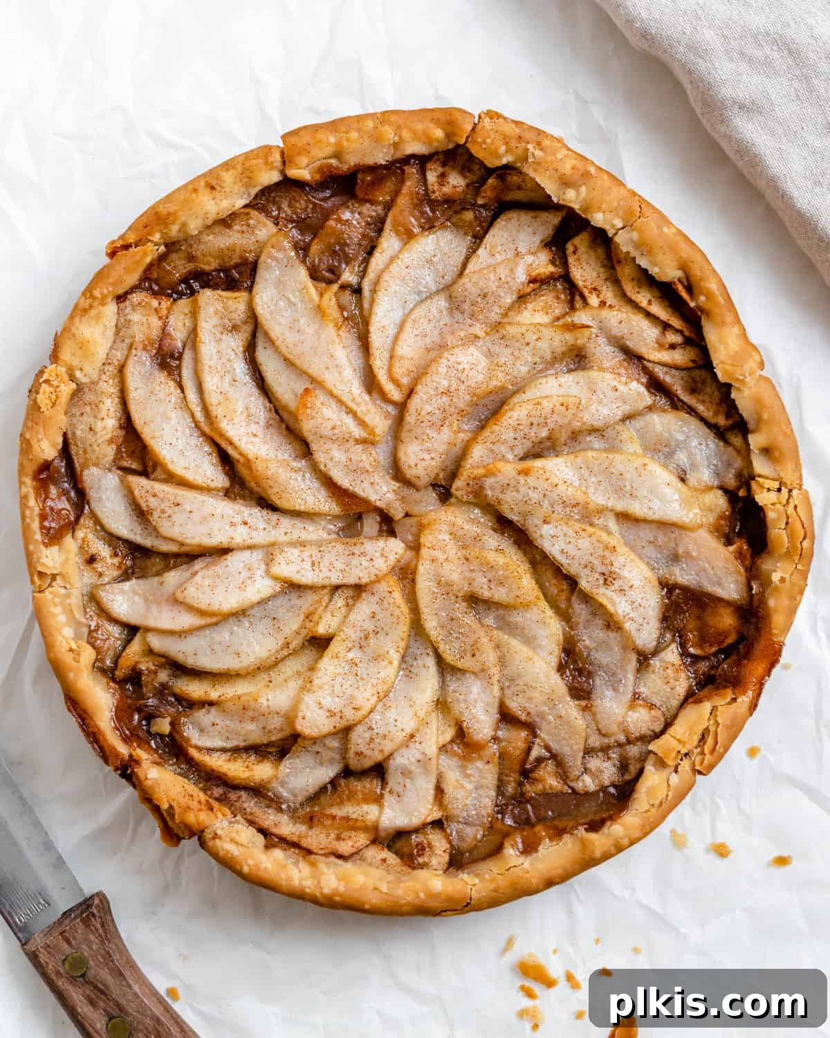 48 Irresistible Vegan Apple Delights 34 Completed Easy Apple Pear Pie against a white surface.