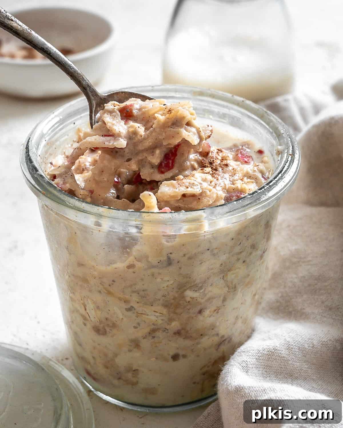 48 Irresistible Vegan Apple Delights 6 Completed Apple Cinnamon Overnight Oats in a glass cup.
