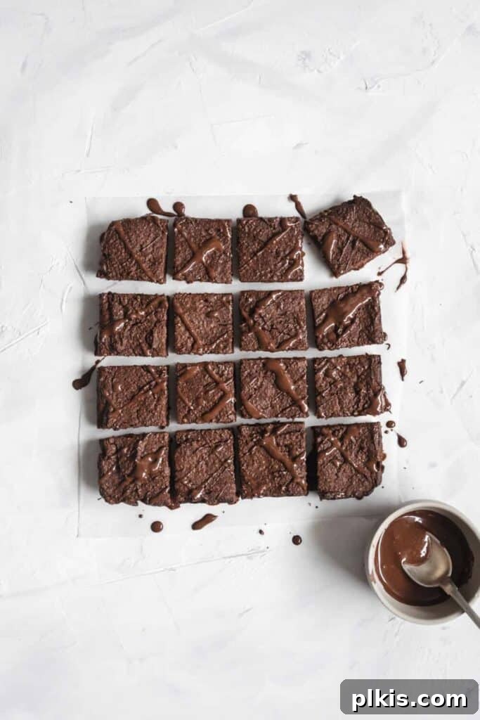 24 Effortless Plant-Based Pumpkin Creations from a Can 14 Finished pumpkin chocolate brownies, cut into neat squares and arranged appealingly against a clean white background.