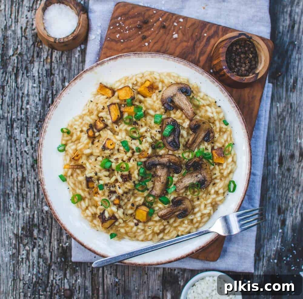 24 Effortless Plant-Based Pumpkin Creations from a Can 15 A perfectly plated Pumpkin Risotto, rich and creamy, served on a white plate against a sophisticated gray background.