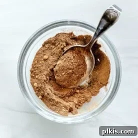 A smaller image of pumpkin spice in a glass bowl, ready for use, against a white background.