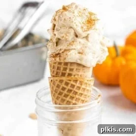 A smaller image of pumpkin ice cream in a cone, presented in a glass jar against a white background.