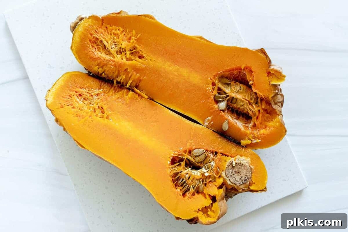 A large platter filled with beautifully roasted butternut squash cubes, seasoned to perfection and ready to be served.