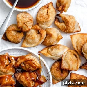Golden Crispy Tofu Vegetable Wontons Made Two Ways 15 several completed Tofu Vegetable Crispy Wontons spread out on a white surface