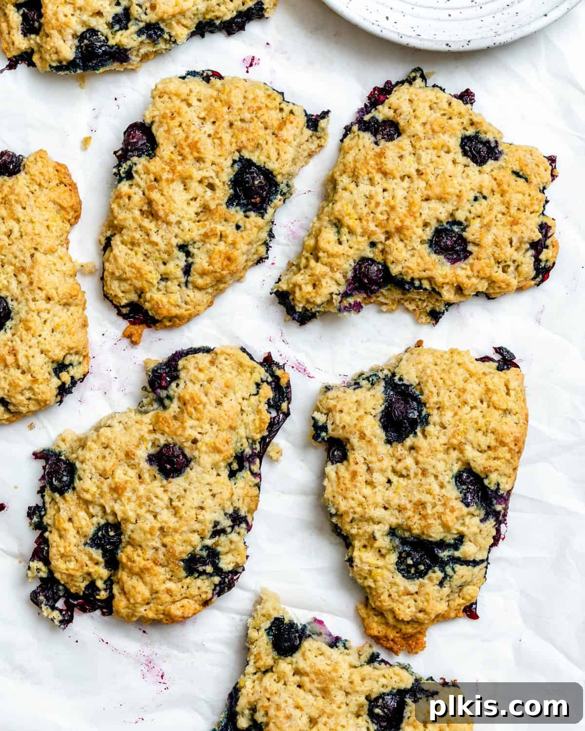 Sunshine Lemon Blueberry Plant-Based Scones 13 A close-up of a completed Vegan Lemon Blueberry Scone, showing its tender interior, juicy blueberries, and crispy edge.