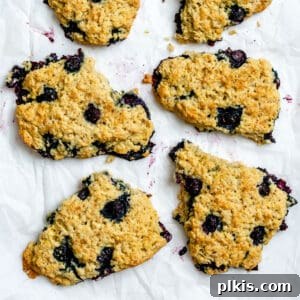 Sunshine Lemon Blueberry Plant-Based Scones 14 completed Vegan Lemon Blueberry Scones scattered on a white surface