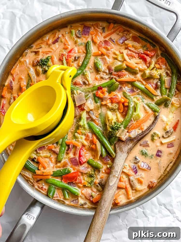 Vibrant 30-Minute Vegan Thai Red Curry 8 Step-by-step image of squeezing fresh lime juice into the finished vegan red curry