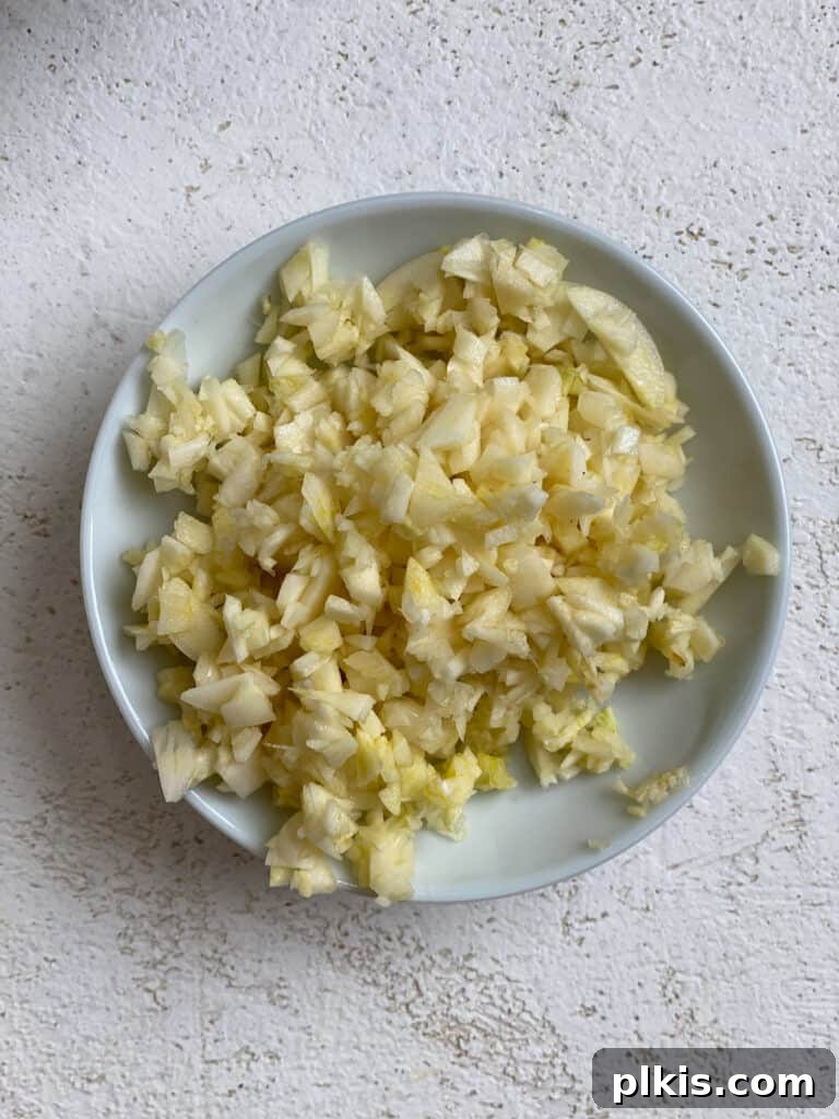 Aromatic Garlic Rice 4 Freshly minced garlic ready to be added to the pan for an aromatic Golden Garlic Rice recipe.