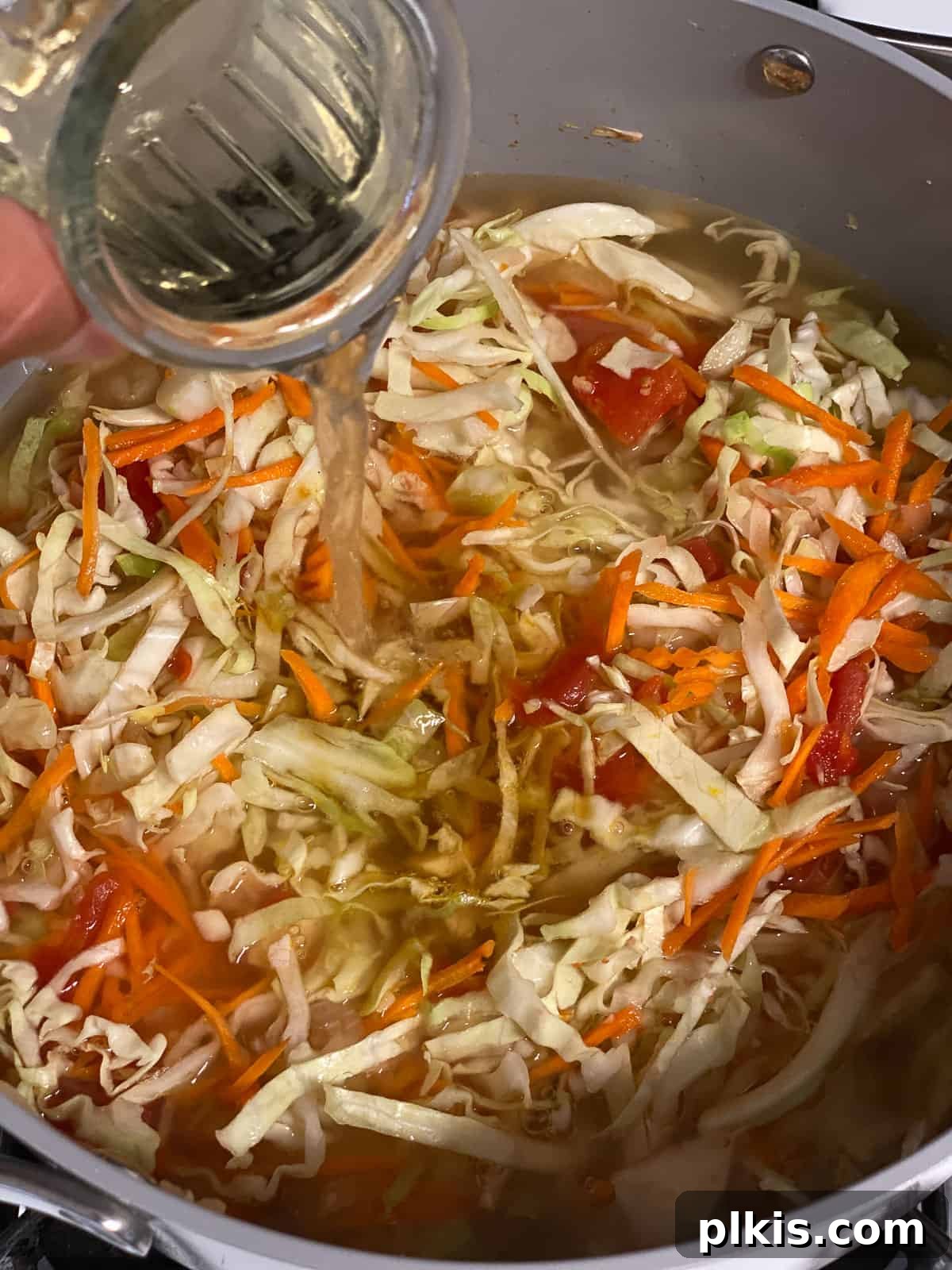 Zesty Plant-Based Hot and Sour Soup 12 process shot of adding rice wine vinegar to pan