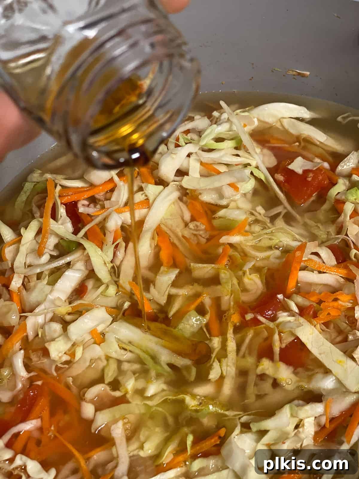 Zesty Plant-Based Hot and Sour Soup 13 process shot of adding rice wine vinegar to pan