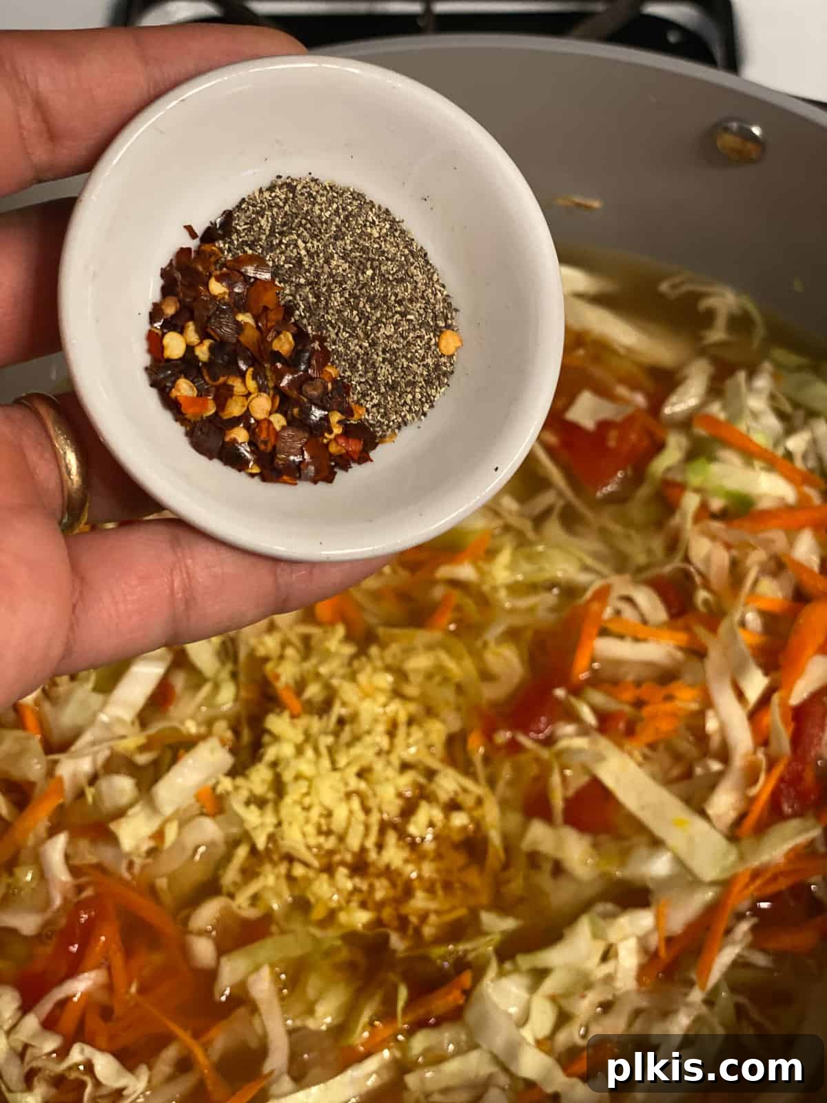 Zesty Plant-Based Hot and Sour Soup 15 process shot of adding spices to pan