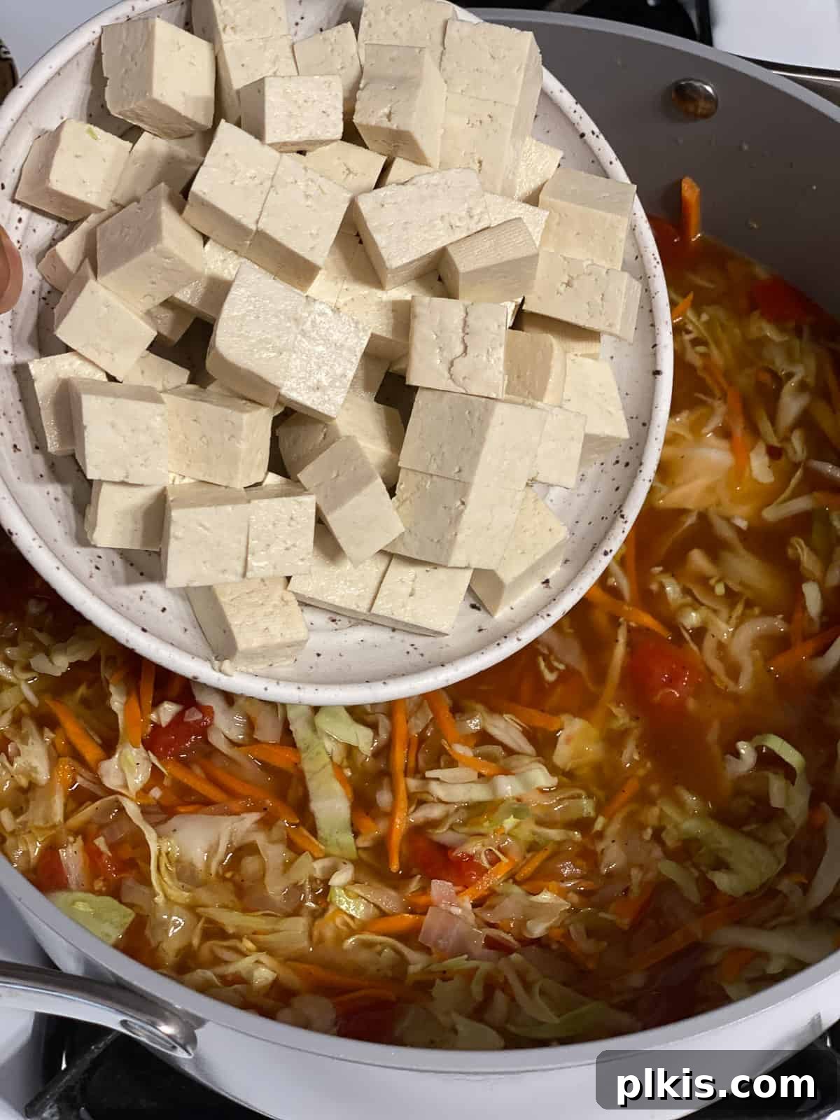 Zesty Plant-Based Hot and Sour Soup 16 process shot of adding tofu to pan