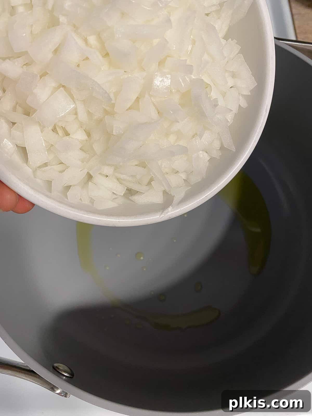 Zesty Plant-Based Hot and Sour Soup 4 process shot of adding onion to pan