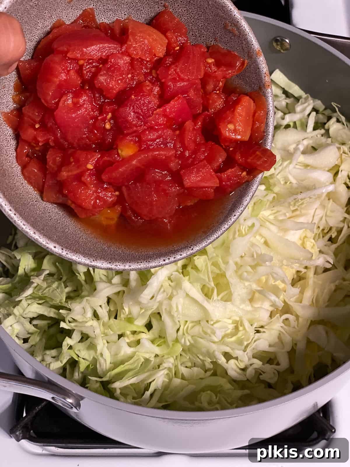 Zesty Plant-Based Hot and Sour Soup 6 process shot of adding tomatoes to pan