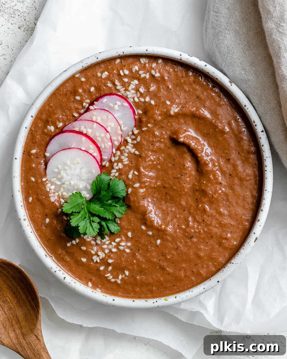 Decadent Vegan Mole 2 A vibrant bowl of Quick Vegan Mole Poblano sauce, garnished with sesame seeds and cilantro.