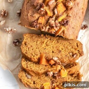 Completed pumpkin bread sliced on parchment paper, ready to be served.
