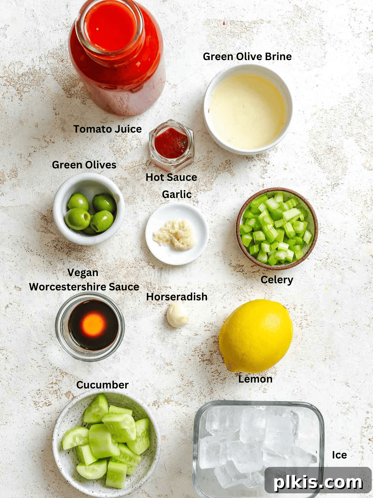 Alkolsüz Bloody Mary Tarifi 3 A selection of fresh ingredients including tomato juice, cucumber, celery, garlic, and hot sauce laid out for making a Virgin Bloody Mary.