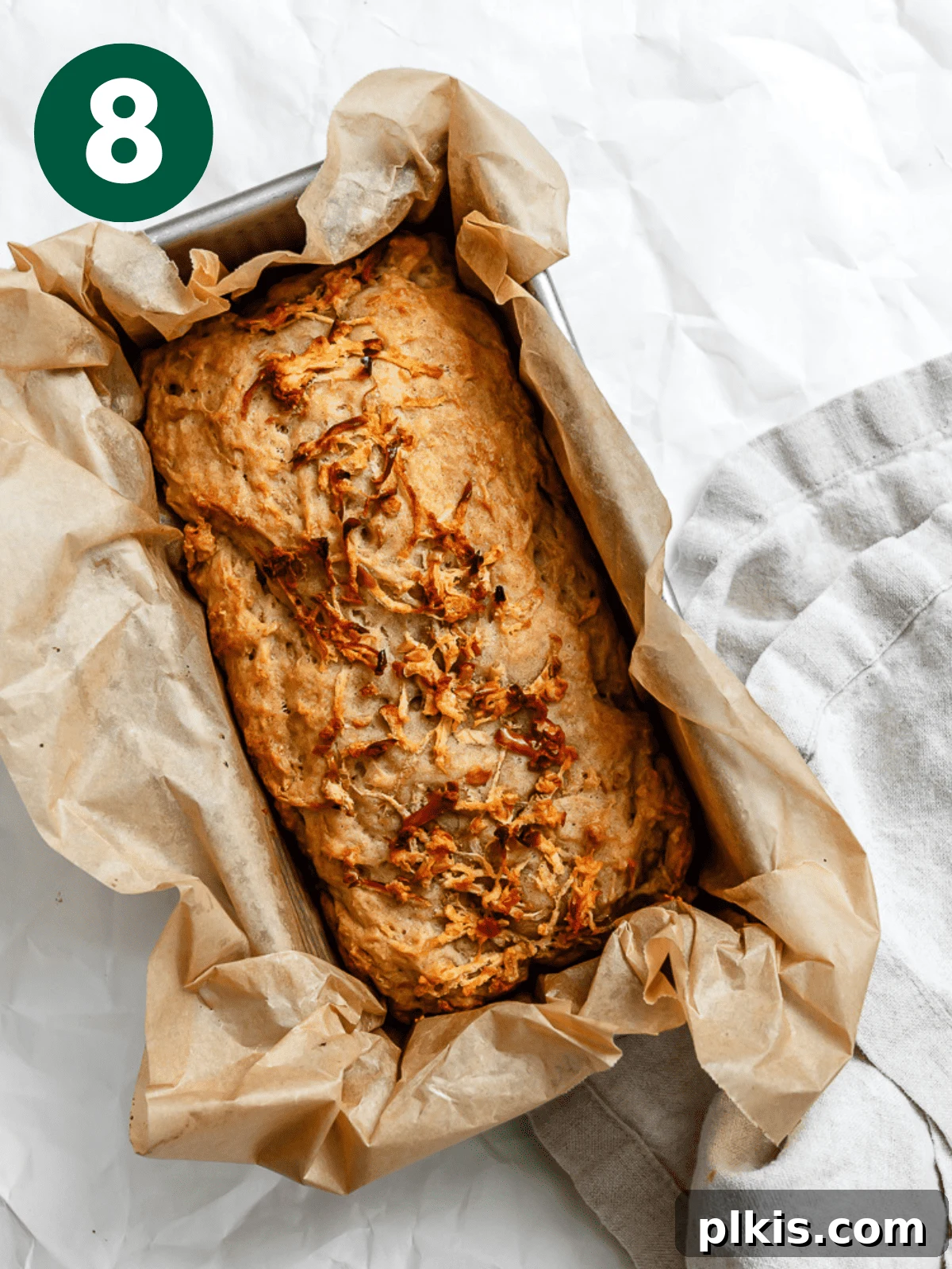 Spiced Apple Bread 11 A freshly baked vegan Apple Cinnamon Bread, golden brown and perfectly domed, cooling in its loaf pan.