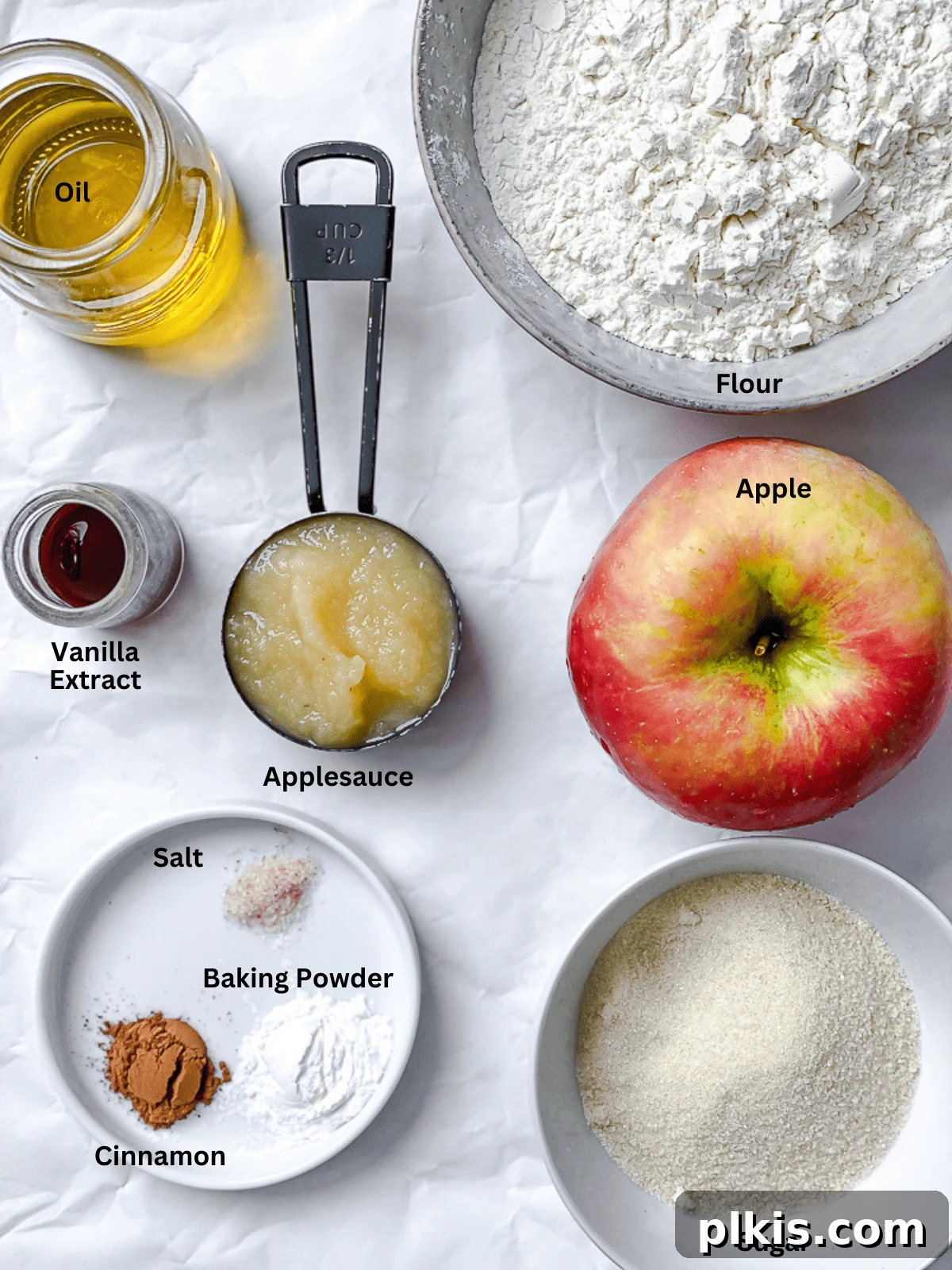 Spiced Apple Bread 3 A flat lay photograph showcasing the individual ingredients required for making apple cinnamon bread, neatly arranged and labeled.