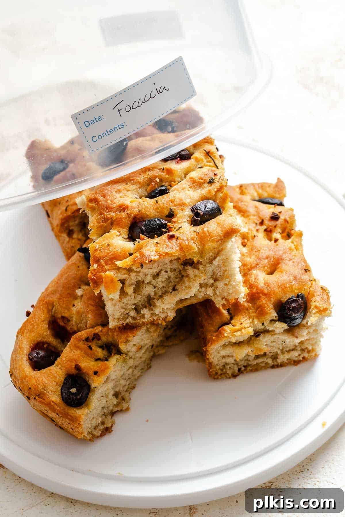 Aromatic Garlic Herb Vegan Focaccia 11 Completed Vegan Focaccia (Garlic and Herb) in a storage container.