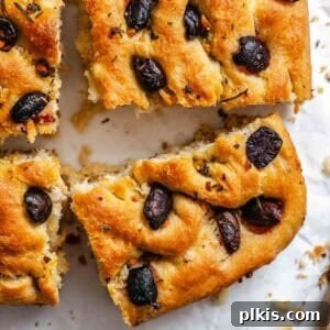 Aromatic Garlic Herb Vegan Focaccia 12 Completed Vegan Focaccia (Garlic and Herb) on a white surface.