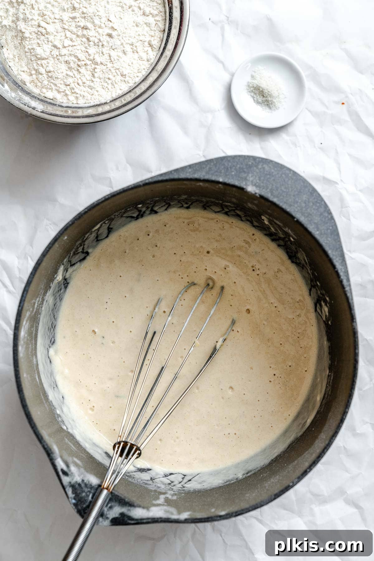 Aromatic Garlic Herb Vegan Focaccia 5 Process shot showing whisking ingredients in pan.