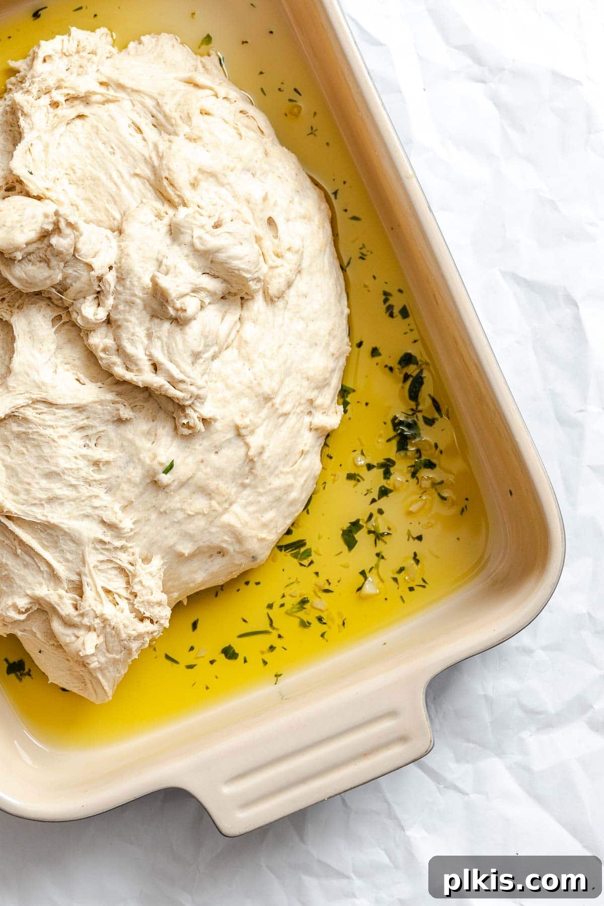 Aromatic Garlic Herb Vegan Focaccia 7 Process shot showing dough added to baking dish.