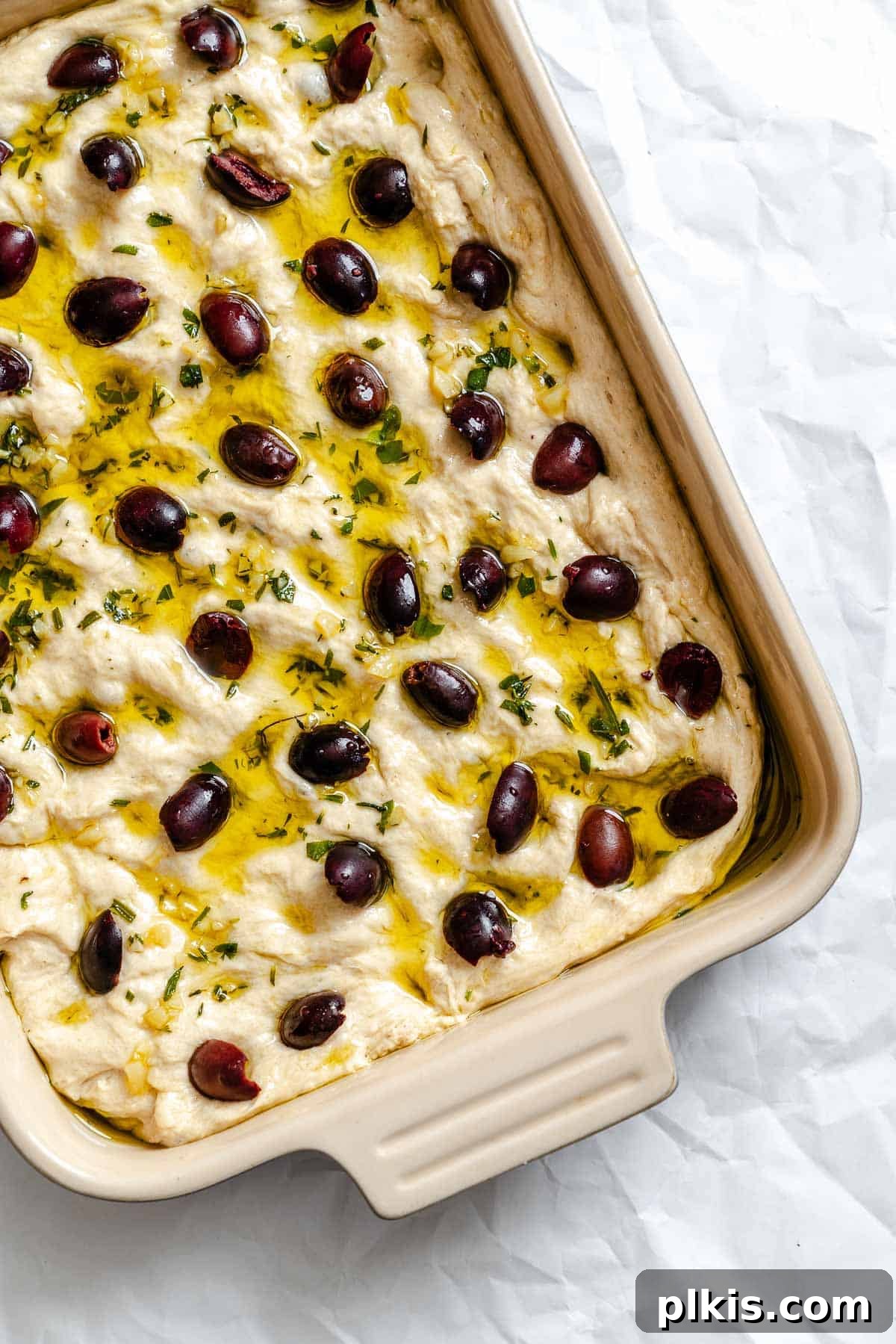 Aromatic Garlic Herb Vegan Focaccia 9 Process shot showing pre-baked Vegan Focaccia (Garlic and Herb) in baking dish.