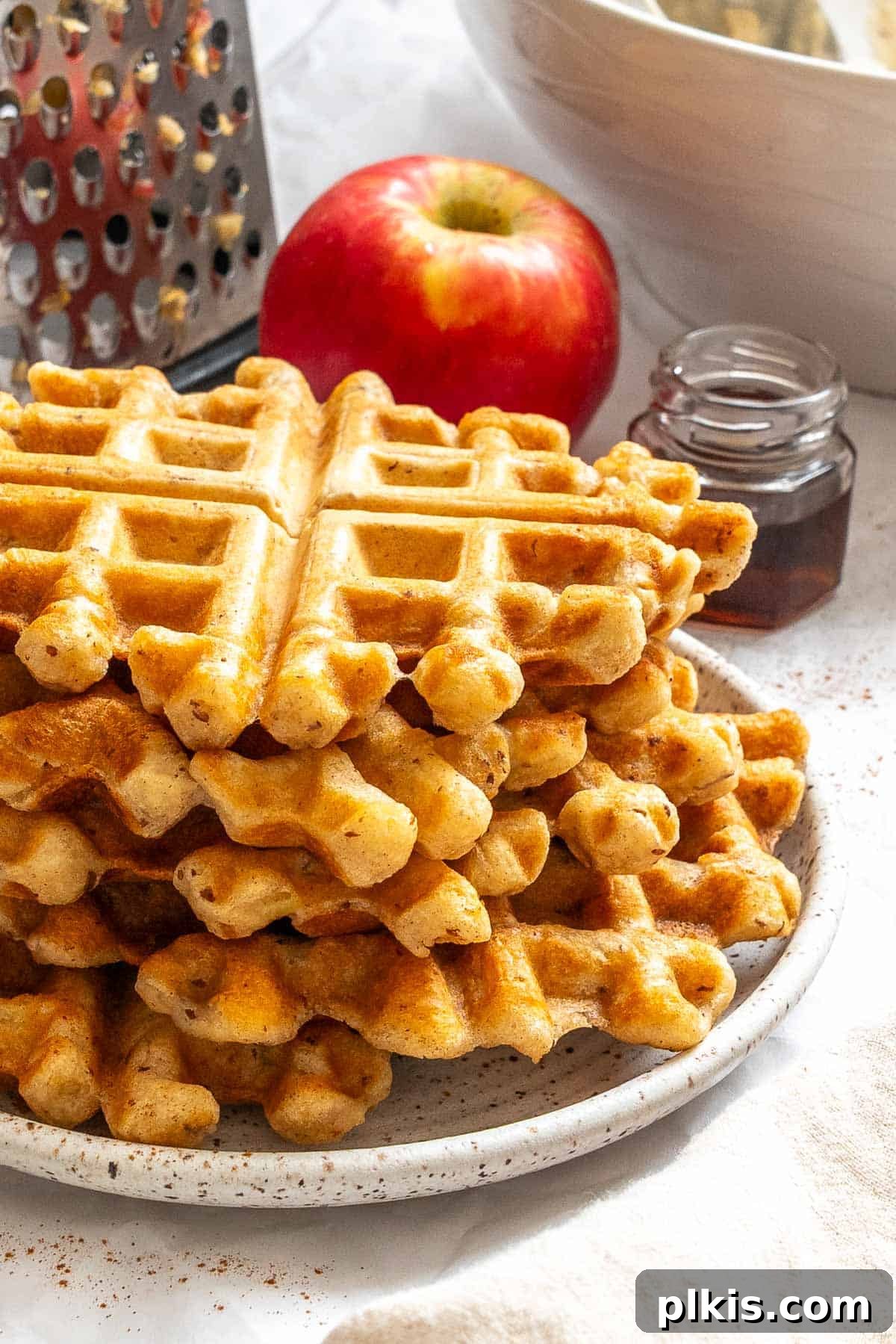 Completed Apple Cinnamon Waffles (Eggless) stacked on a plate.