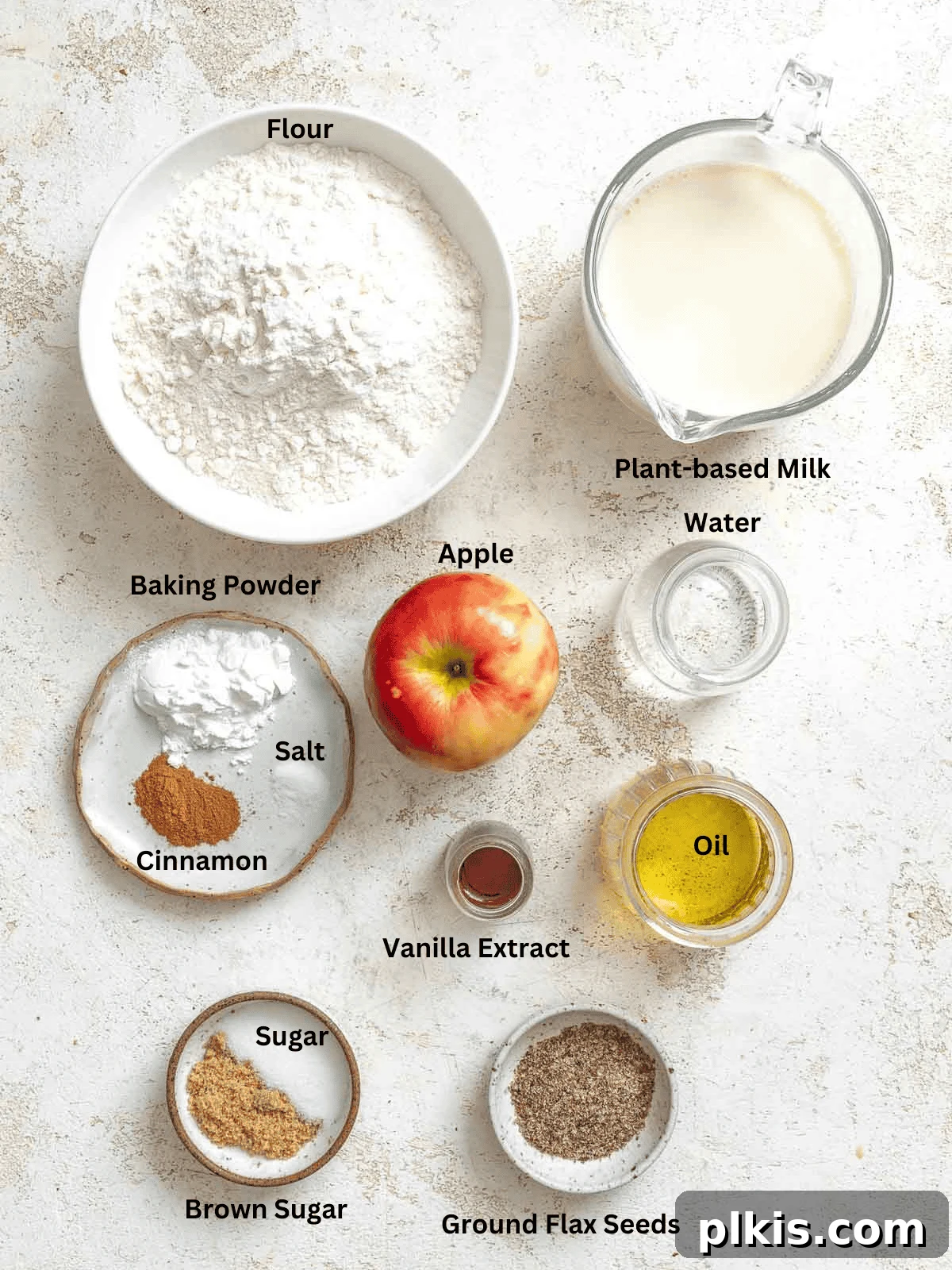 Ingredients for Apple Cinnamon Waffles (Eggless) measured out on a white surface.