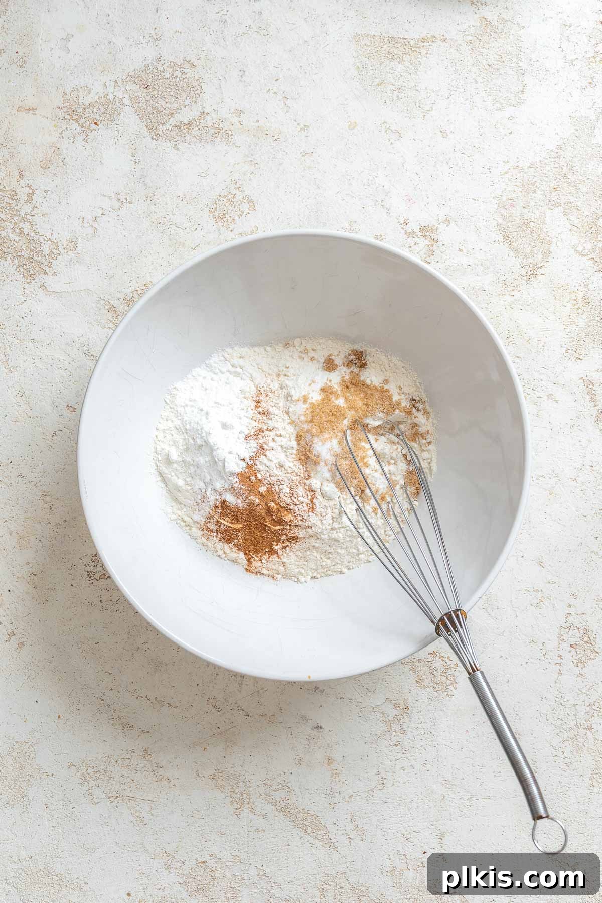 Process shot showing mixing ingredients in a bowl.