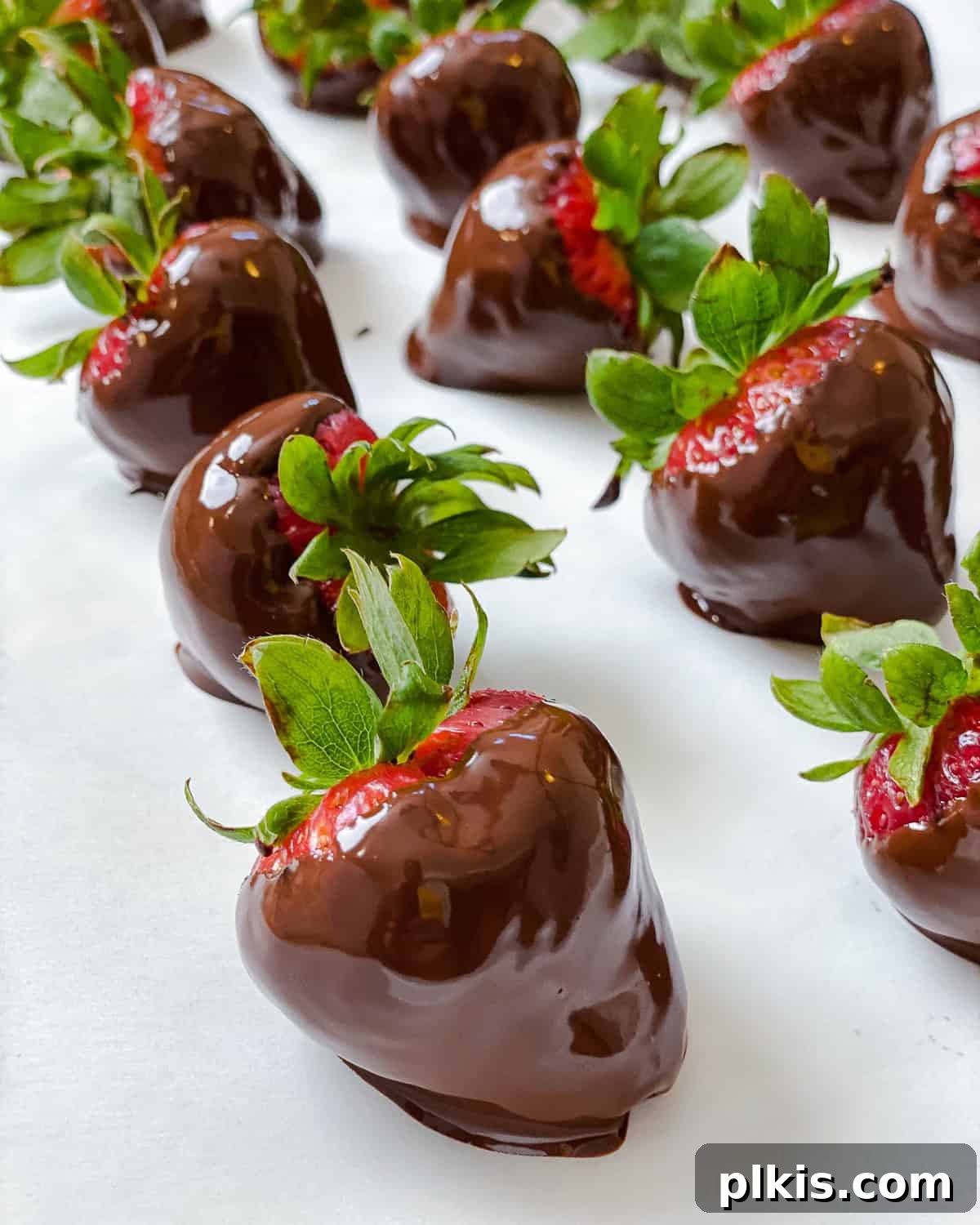 Decadent Vegan Strawberry Bites 7 Several completed Chocolate Dipped Strawberries on a white surface.