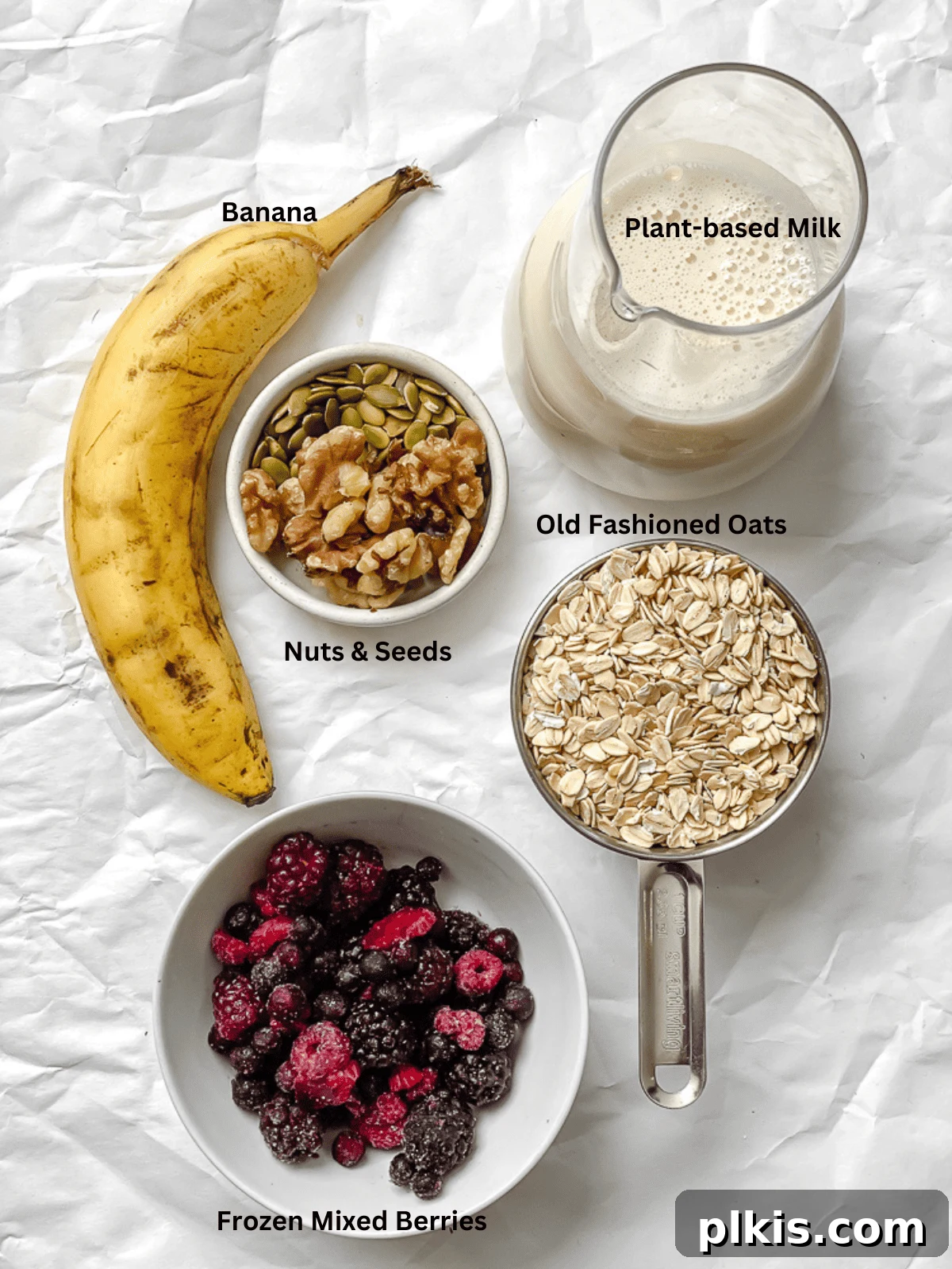 Mastering Stove-Top Oatmeal: Perfect Consistency and Delicious Variations 3 A flat lay photograph showcasing the simple ingredients required to cook oatmeal on the stove, including oats, plant-based milk, and fresh berries.