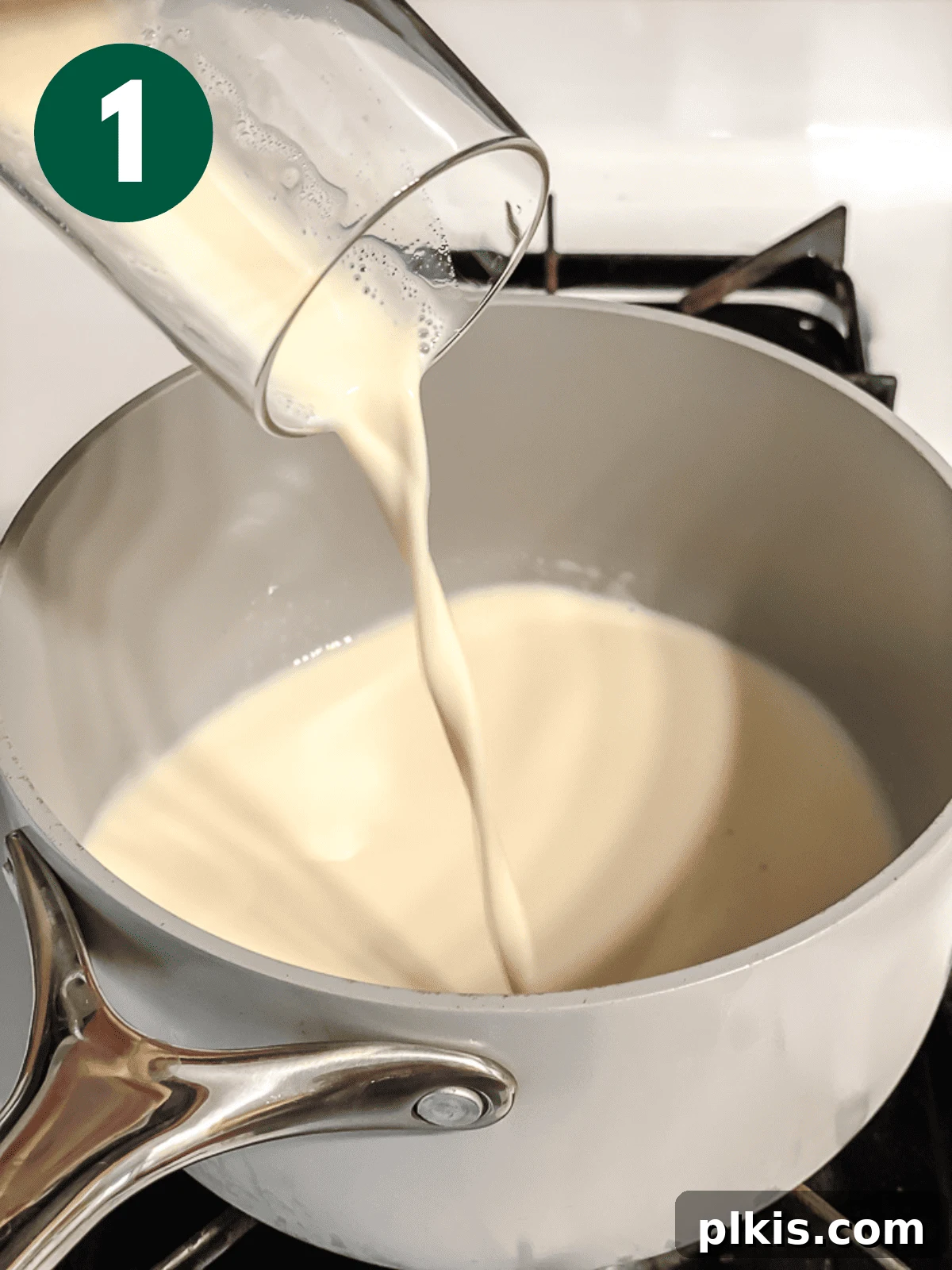 Mastering Stove-Top Oatmeal: Perfect Consistency and Delicious Variations 4 Process shot of plant-based milk being poured into a saucepan, indicating the first step of cooking oatmeal.