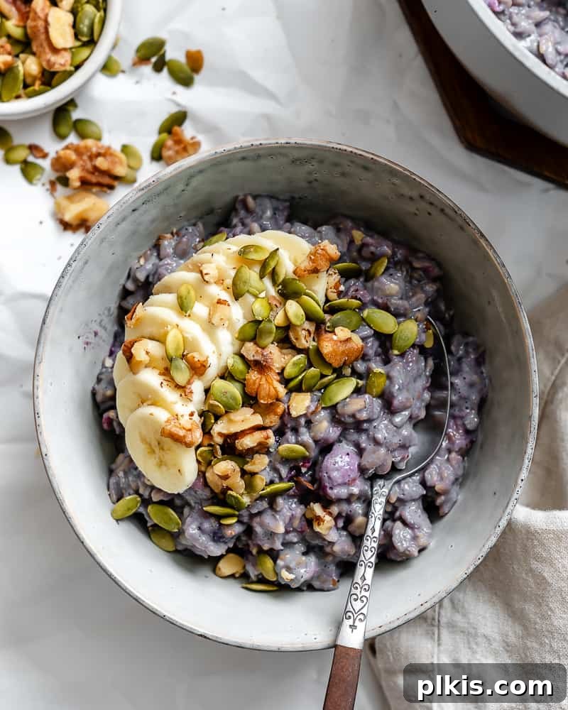 Mastering Stove-Top Oatmeal: Perfect Consistency and Delicious Variations 8 A close-up shot of creamy stovetop oatmeal in a bowl, topped with fresh fruit and nuts, highlighting its perfect texture.