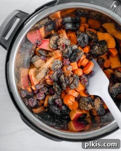All ingredients for Pressure Cooker Tzimmes mixed together inside the pressure cooker pot before cooking