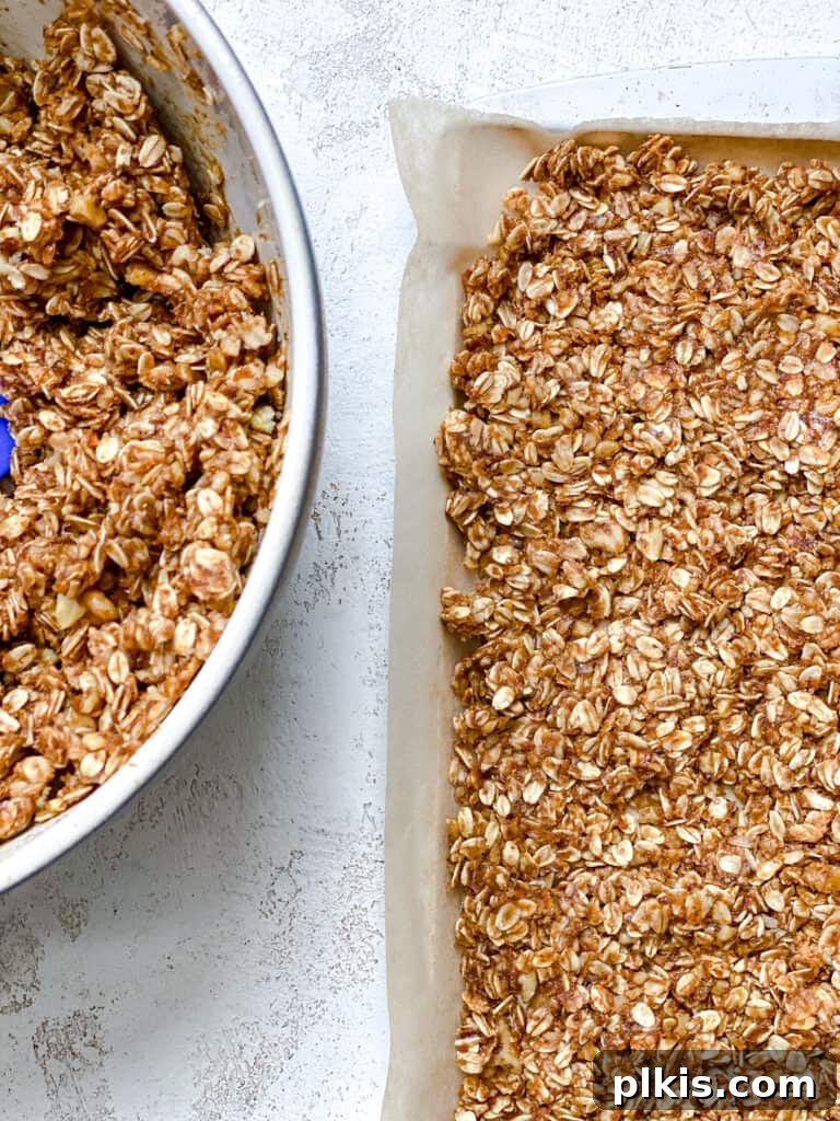Simple Peanut Butter Granola Clusters 11 process shot of adding peanut butter mixture to baking dish