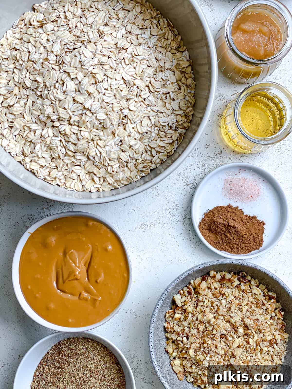 Simple Peanut Butter Granola Clusters 3 ingredients for Easy Peanut Butter Granola measured out against a white surface